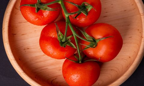Tomatoes on vine in a bowl