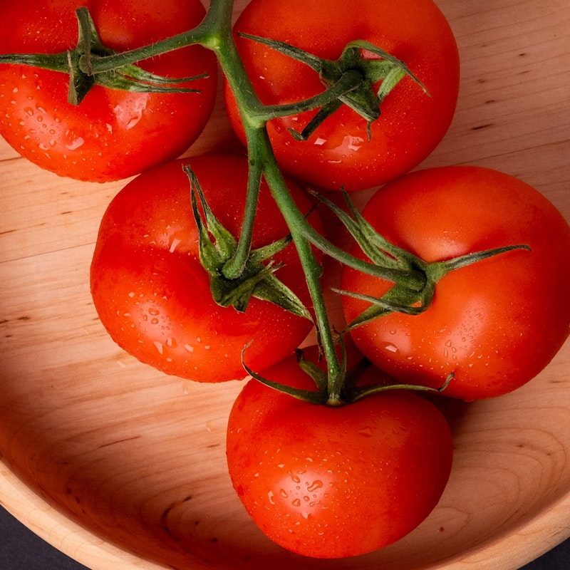 Tomatoes on vine in bowl