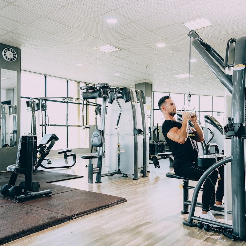 man doing lat pull-down.