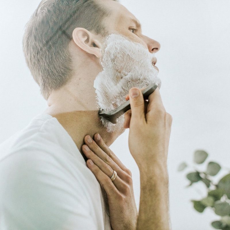 Man shaving face with razor burn.