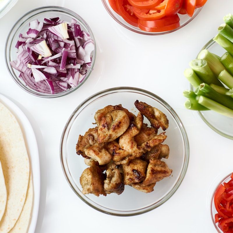 Meat and vegetables next to tortillas