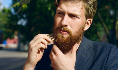 Bearded man grooming facial hair