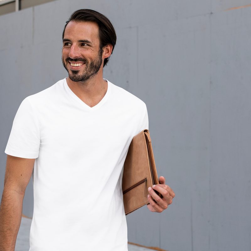 Man walking in a white V-neck shirt