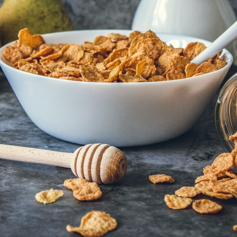 Cereal in bowl with honey