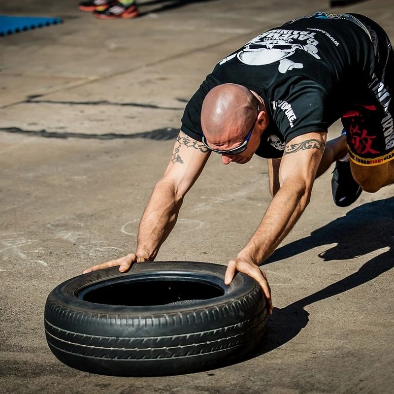 Man using tire crossfit workout