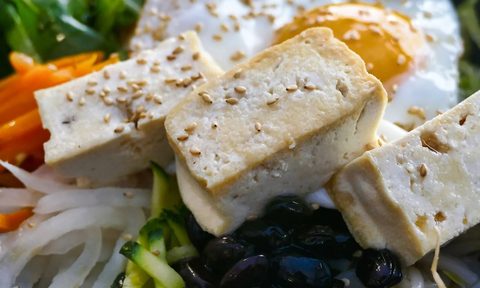 Cubed tofu on top of a salad