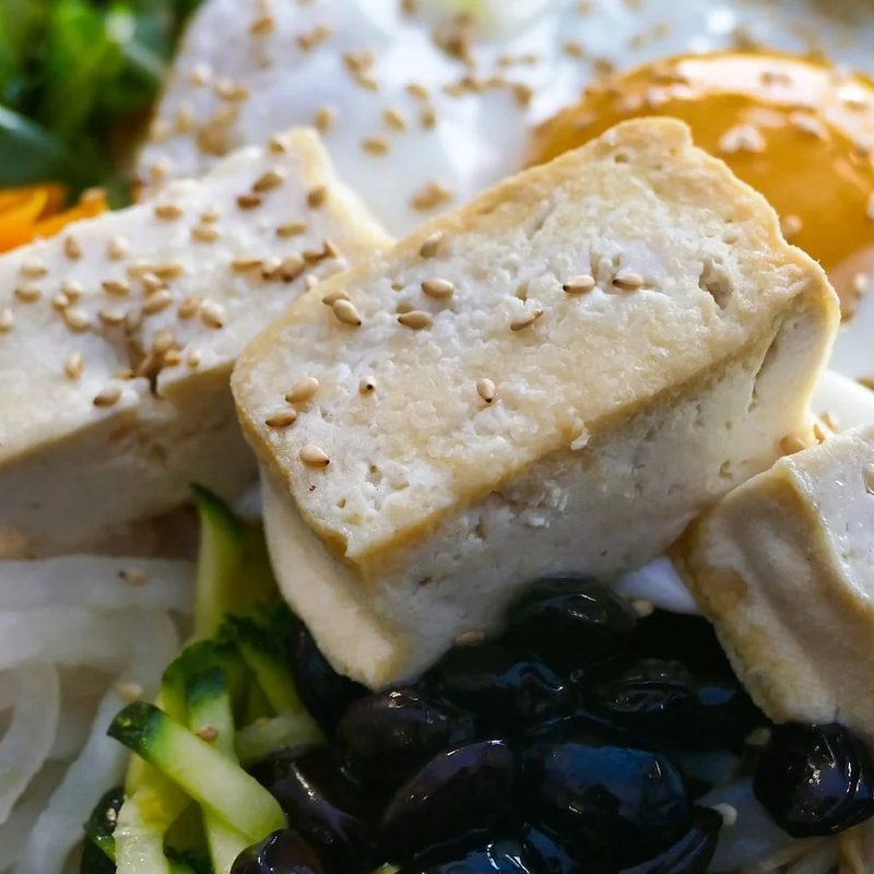 Cubed tofu on top of a salad