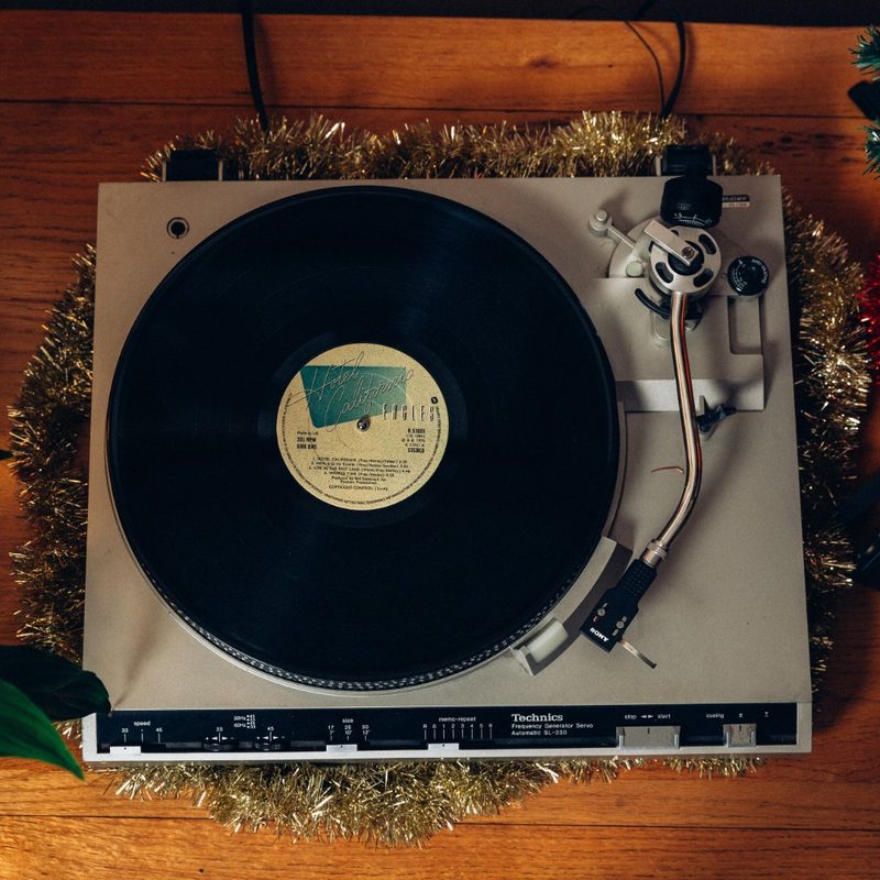 turntable with a record on it decorated with garland.