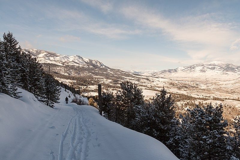 View of a valley and mountains covered in snow.