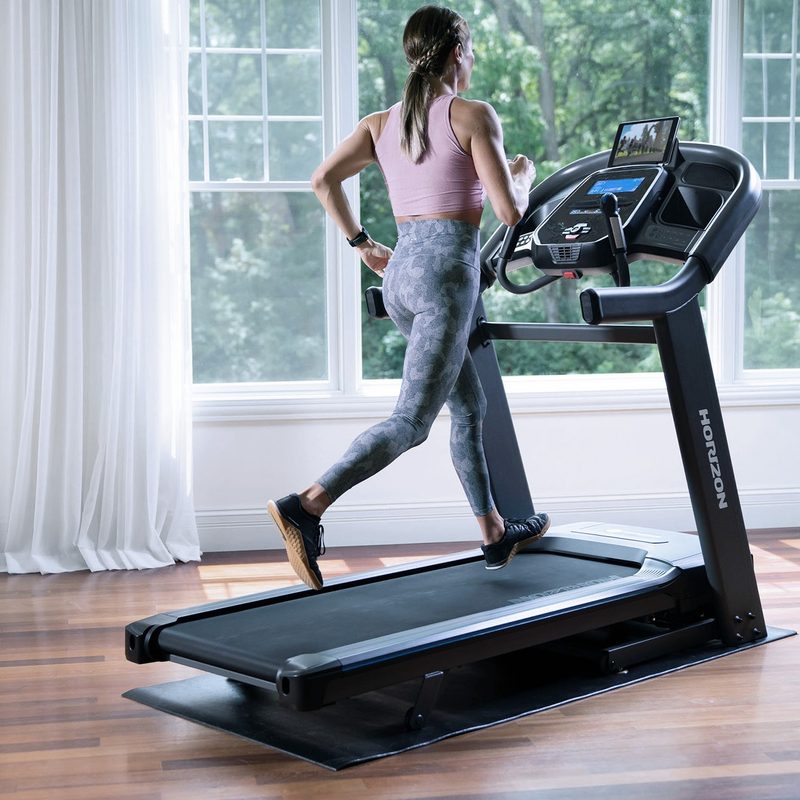 Horizon Fitness treadmill with woman working out.