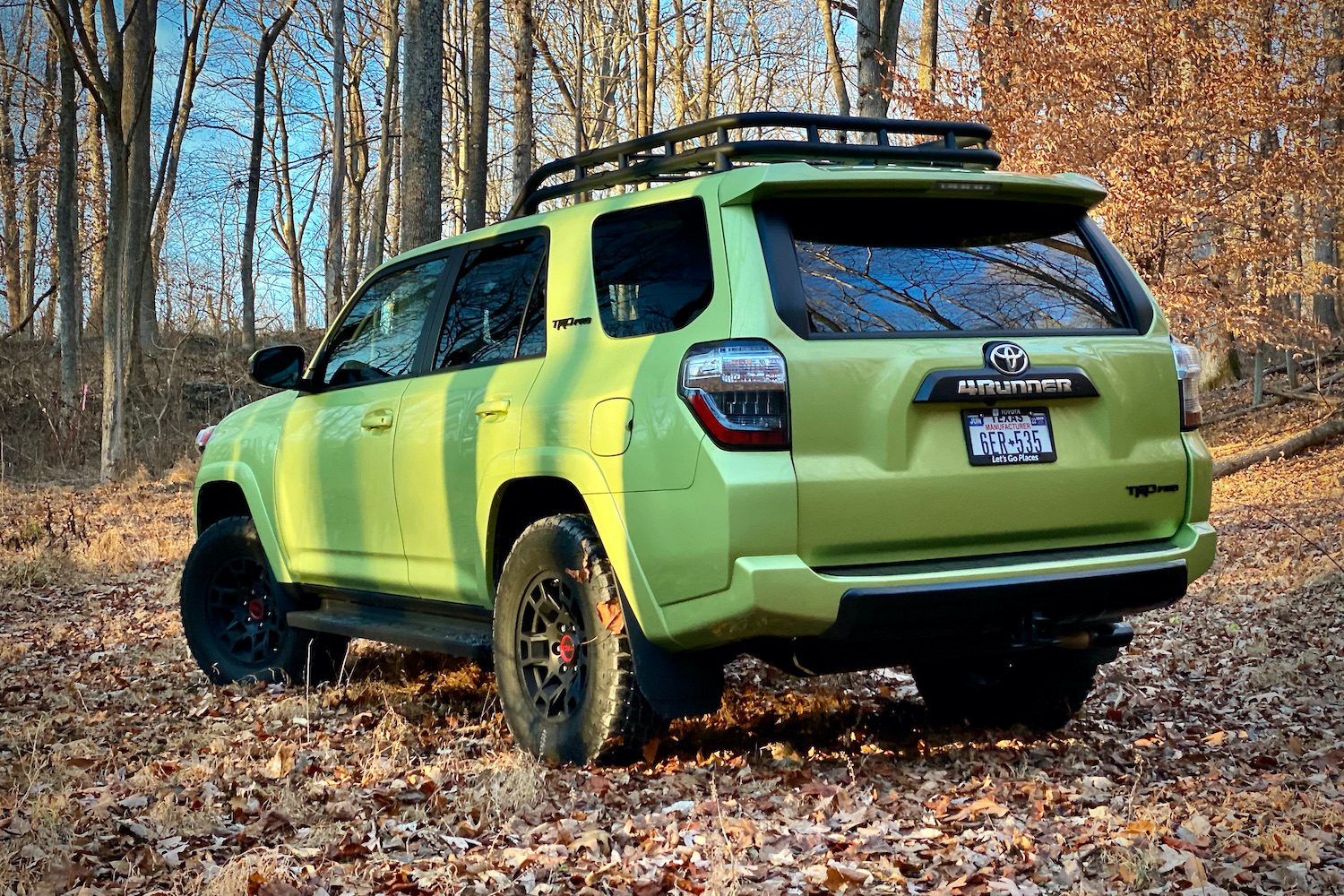 Rear end of Toyota 4Runner TRD Pro from driver's side with trees in the back.