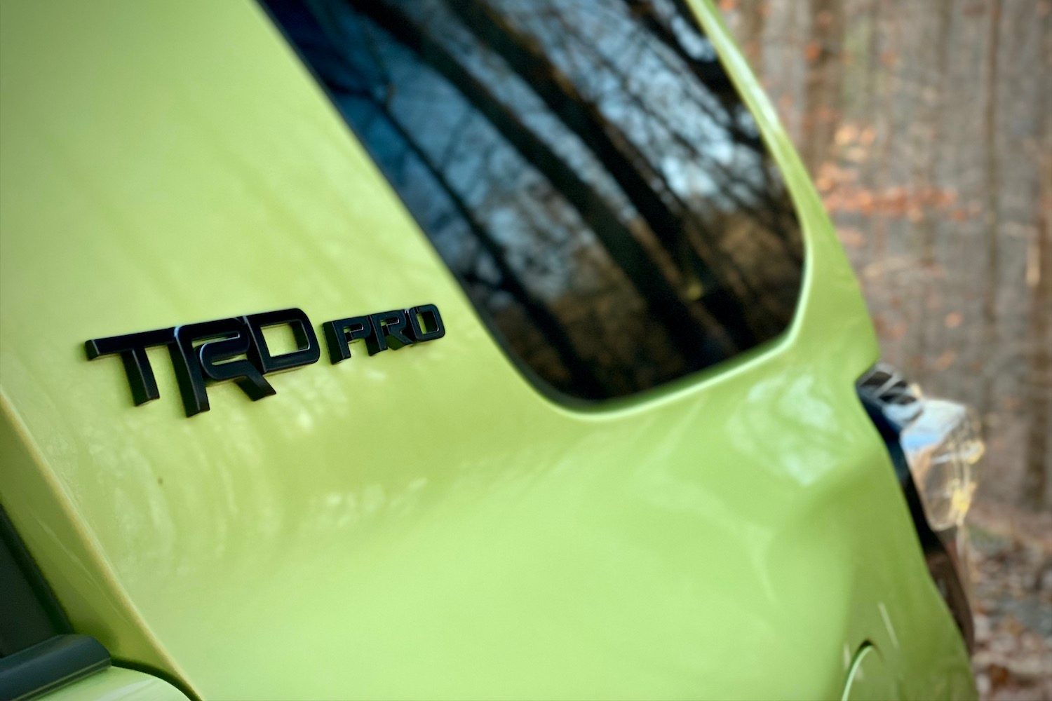Rear badges on 2022 Toyota 4Runner TRD Pro in front of trees.
