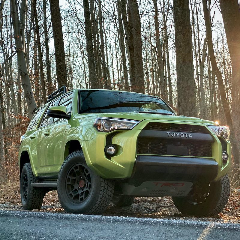 Front end of Toyota 4Runner TRD Pro from passenger side with trees in the back.