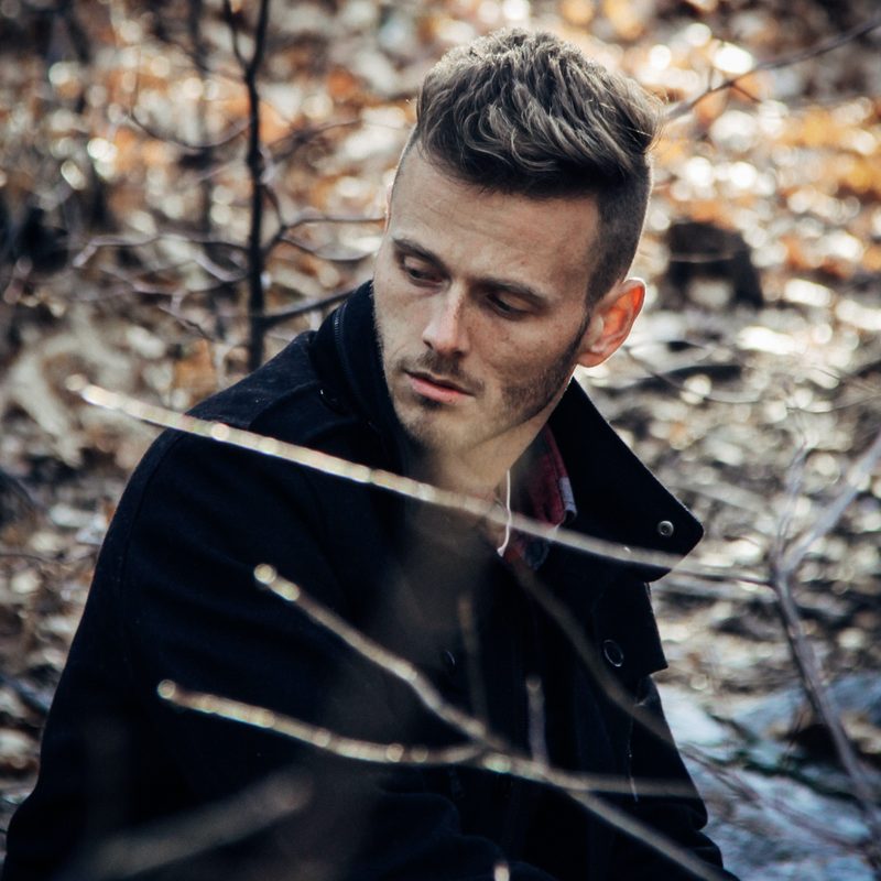 Man in the woods wearing a jacket