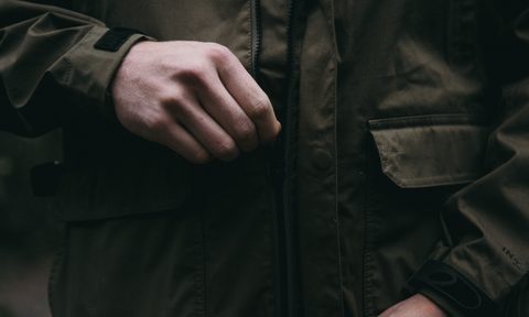 Man zipping up a jacket