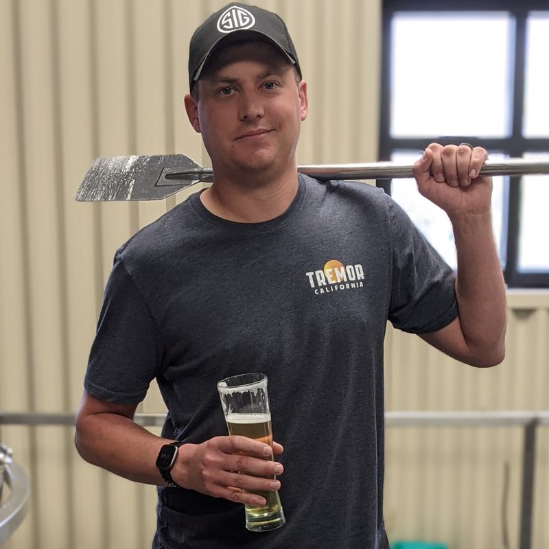 Andy Hooper brewer holding glass of beer.