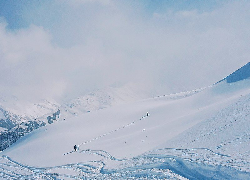 Skiers hiking up Arlberg Ski Area, Austria.