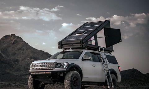 Redtail Overland carbon fiber rooftop tent on a white SUV camping in the mountains.