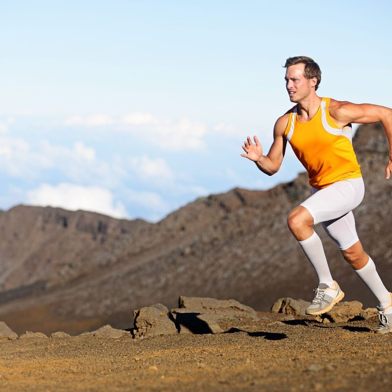 A man in athletic outfit running.