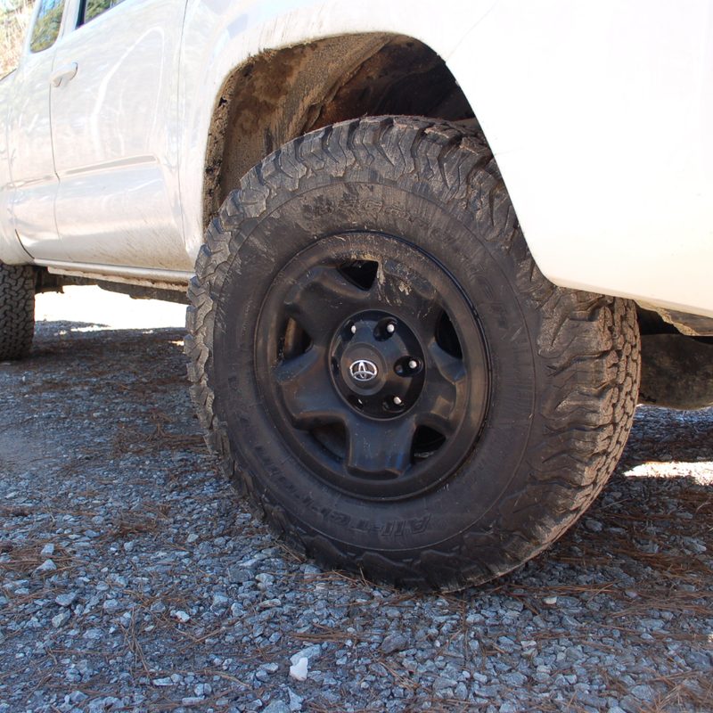 A front view of the BFGoodrich All-Terrain Tire on a white vehicle.