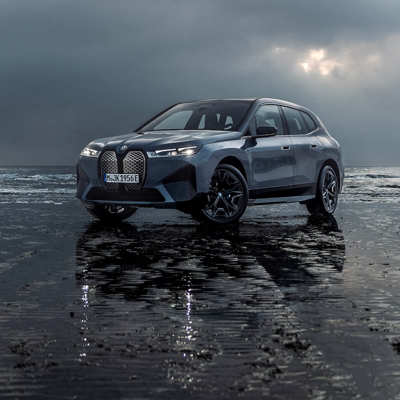 2023 BMW iX M60 SUV on a beach in a storm.