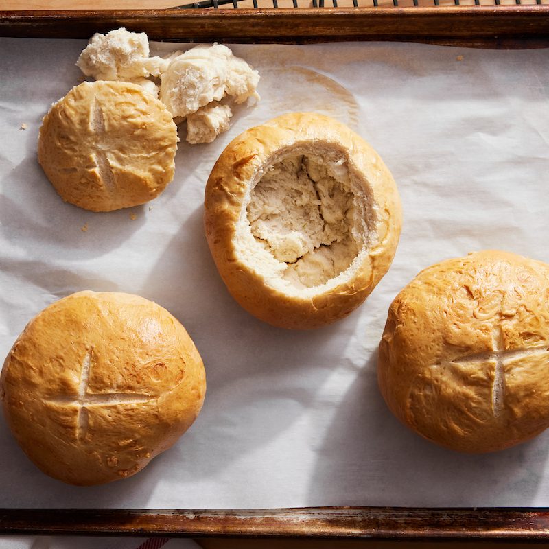 Bread bowls on baking sheet.