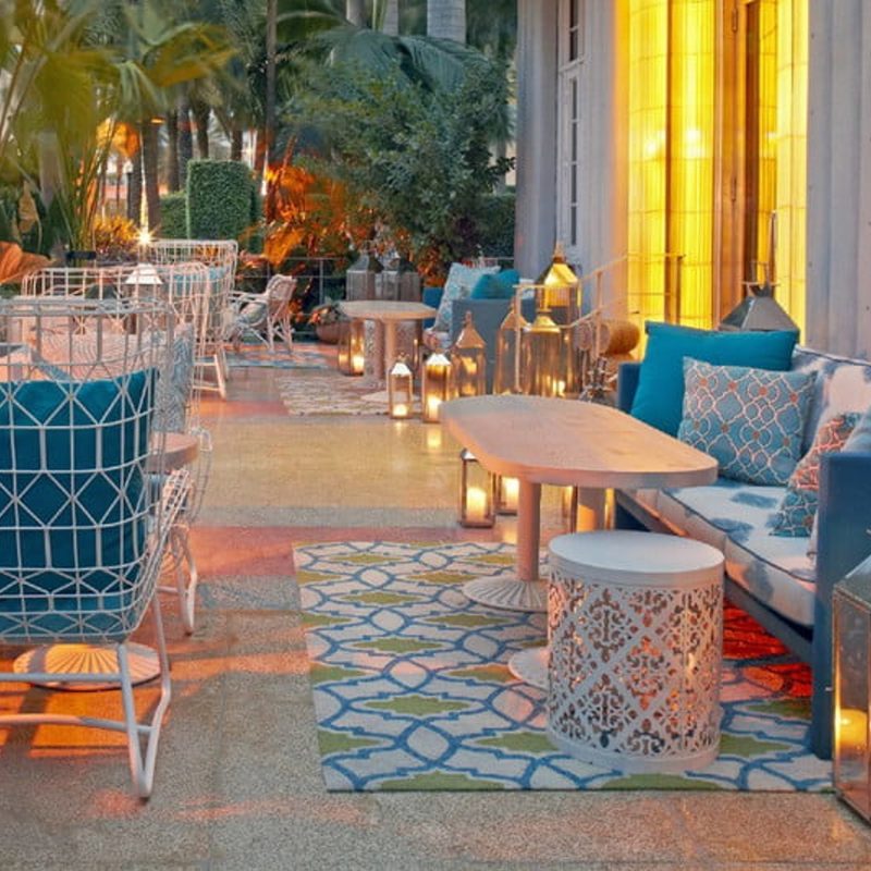 Couch, tables, and chairs at Byblos patio