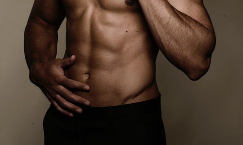 Shirtless man with his hand on his lover belly