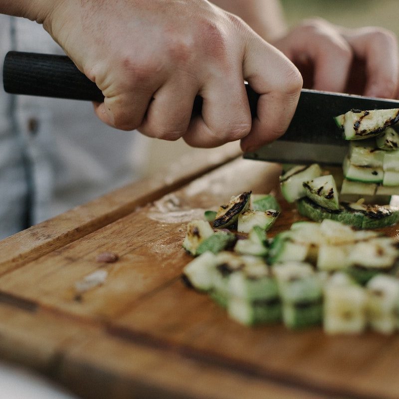 Slicing zucchini with a knife.