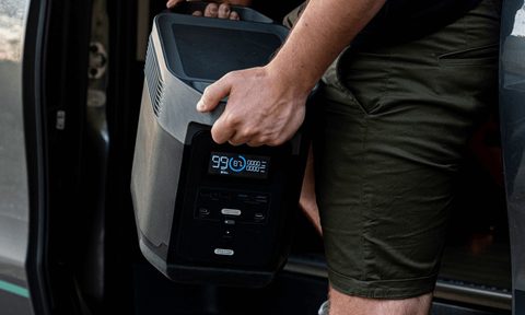 EcoFlow portable power station being unloaded from vehicle.