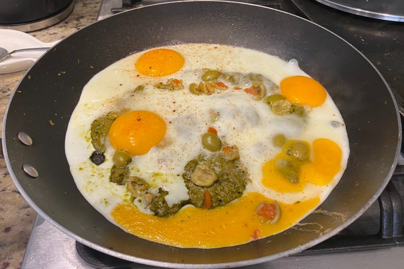Eggs pan-fried in pesto.