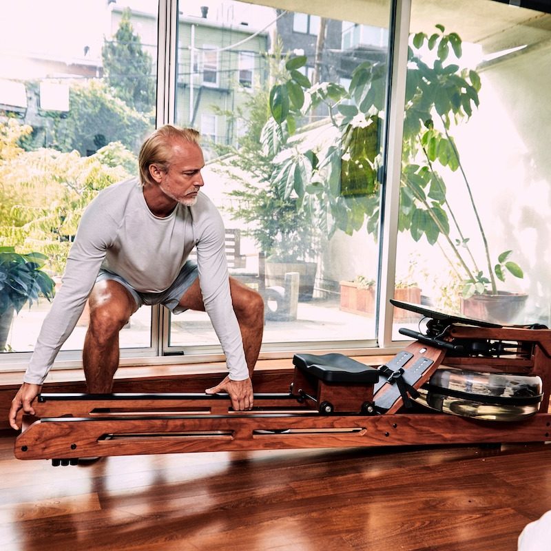 Man lifting up Ergatta rower.