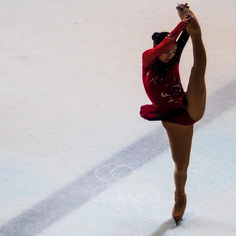 Figure skater with leg above her head.