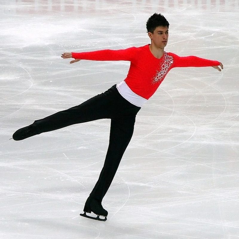 Male figure skater gracefully skating.