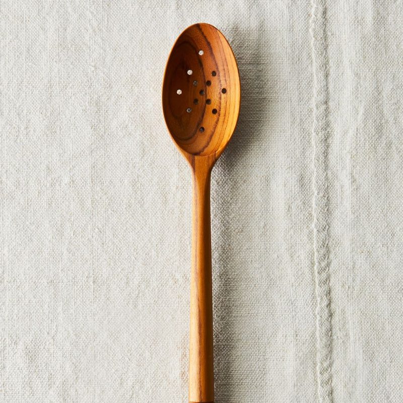 Food 52 Wooden Spoon on a white linen cloth.