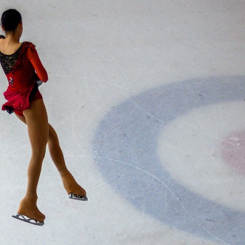 Female figure skater doing a jump.