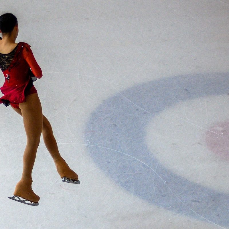 Skater completing triple axel.