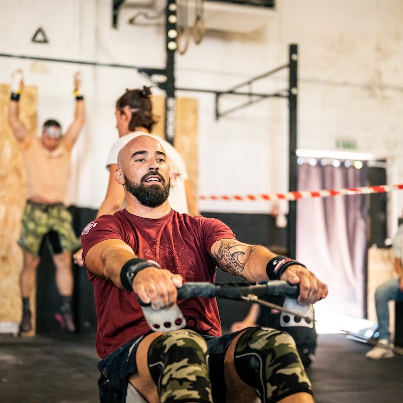 Man rowing in a gym.