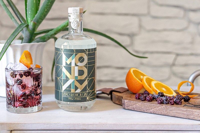 A Monday non-alcoholic gin cocktail and bottle.