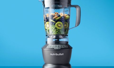 The Nutribullet 1200W full size blender with ingredients inside.
