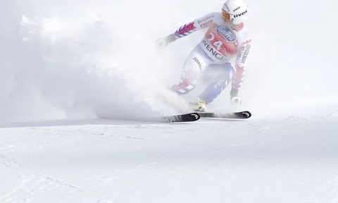 Olympic skiier doing a slalom.