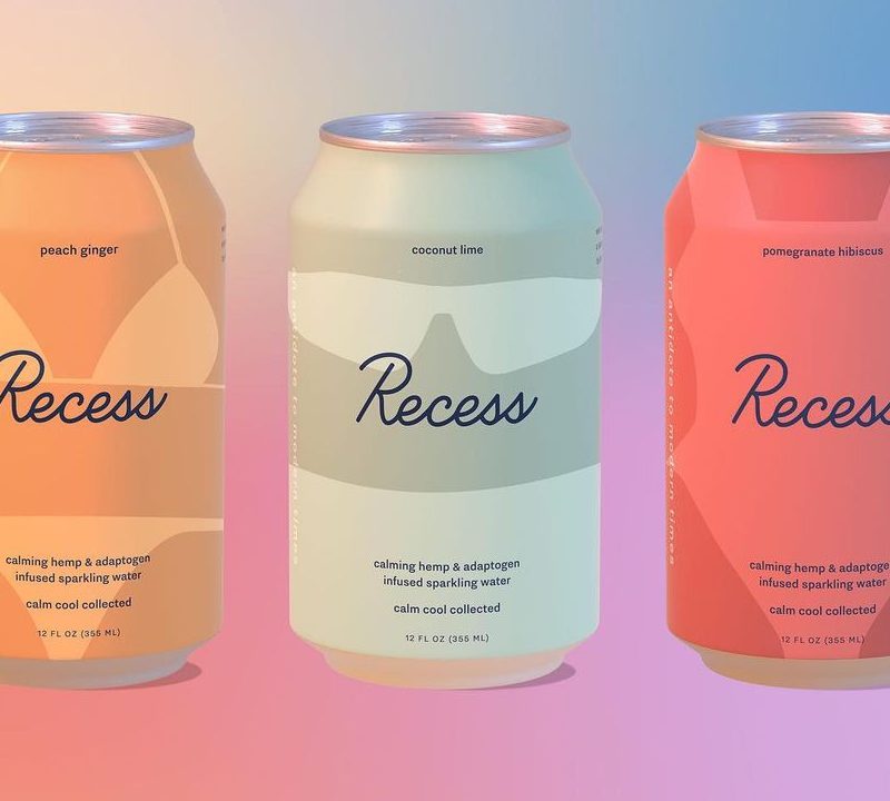 Three cans of Recess CBD beverage with a colorful orange to blue background.