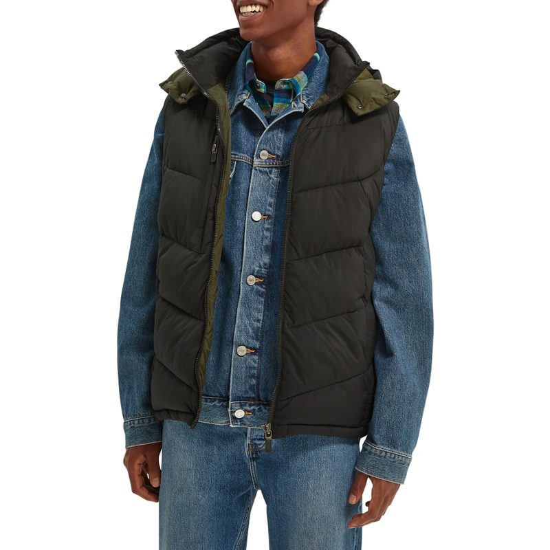 Man wearing a Scotch and Soda Vest over a denim jacket.
