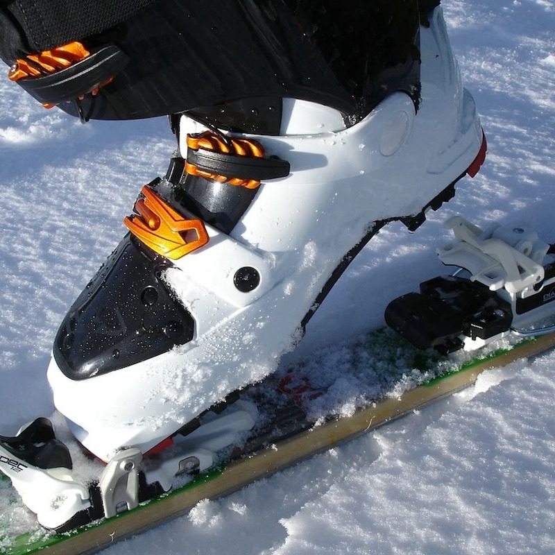 Ski boot being clipped into binding