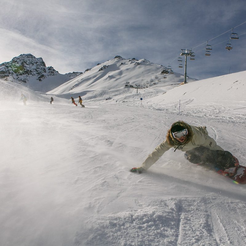 Snowboard cruises down run