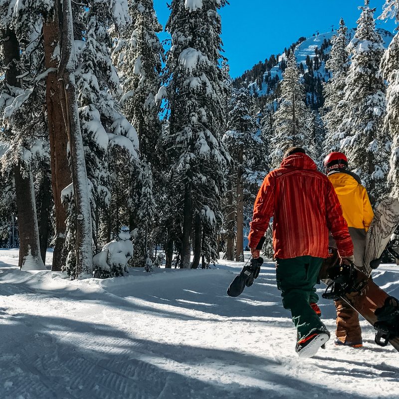 Snowboarders walking