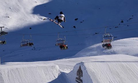 Snowboarder catching some air at the Olympics.