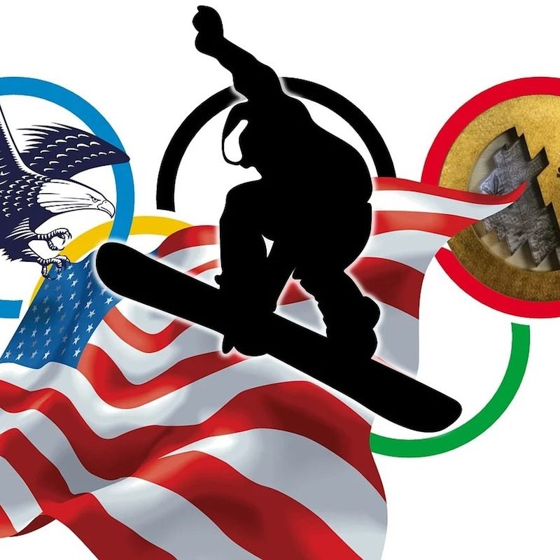 Snowboarder at sochi with olympic emblem.