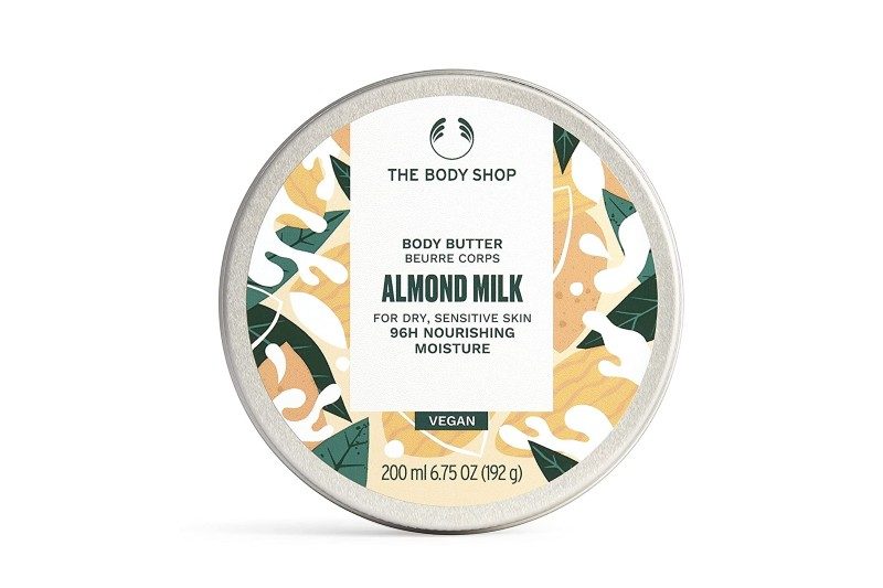 A pot of The Body Shop Almond Milk Body Butter on white background.