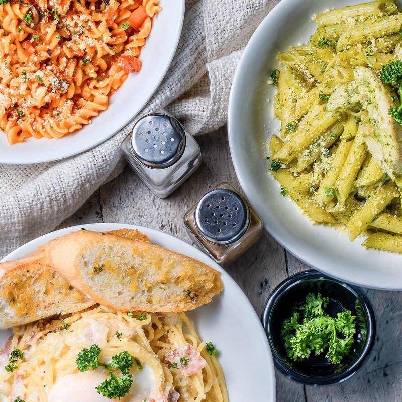 Trio of Italian pastas with salt and pepper shakers.